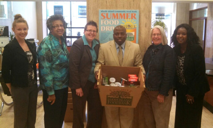 BANK RHODE ISLAND’s Turks Head branch in Providence collected food for the Providence In-Town Churches Association during the company’s seven-week food drive. From left: Shelby Pickering, teller, Bank Rhode Island; Trudy Rawles, teller supervisor, Bank Rhode Island; Sarah Clausius-Parks, Turks Head branch manager; Dwayne Keys, Turks Head branch assistant manager; Diana Burdett, executive director, Providence In-Town Churches Association; and Bara Dia, senior banking specialist, Bank Rhode Island.