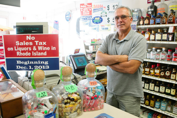 LIVING PROOF: State Rep. Jan Malik is owner of Malik’s Fine Wine & Spirits in Warren. He’s lost sales to Mass. stores that benefit from a sales tax exemption. A temporary exemption will go into effect in R.I. for wine and spirits on Dec. 1. / PBN PHOTO/RUPERT WHITELEY