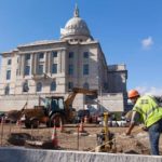 PAVING AWAY: Construction crews work on the expanded parking lot at the Statehouse, a move which has drawn opposition from the Capital Center Commission. / PBN PHOTO/DAVID LEVESQUE