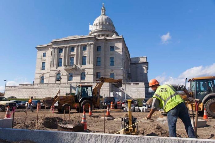 PAVING AWAY: Construction crews work on the expanded parking lot at the Statehouse, a move which has drawn opposition from the Capital Center Commission. / PBN PHOTO/DAVID LEVESQUE