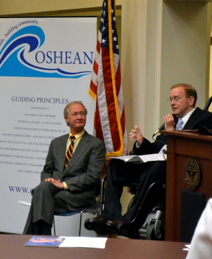 GOV. LINCOLN D. CHAFEE (left) looks on at an event Friday announcing the completion of the Beacon 2.0 fiber-optic network, where Rep. James R. Langevin (right) and others highlighted the significance of the cyberinfrastructure in strengthening Rhode Island's knowledge economy. / COURTESY DK COMMUNICATIONS