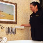 Eco-friendly measures popular with group travelers SEAL OF APPROVAL: Odena Chacon, room attendant at the the Hotel Viking, fills shampoo dispensers. The hotel uses cleaning chemicals that are “Green Seal” certified. / PBN PHOTO/KATE WHITNEY LUCEY