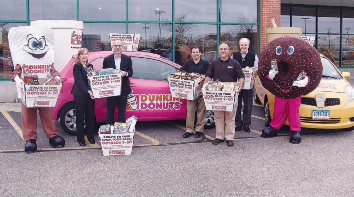 DUNKIN’ DONUTS mascots and representatives from participating franchises deliver supplies to the R.I. Community Food Bank. From left: Joe the Cup; Lisa Roth Blackman, chief philanthropy officer, Rhode Island Community Food Bank; Andrew Schiff, CEO, Rhode Island Community Food Bank; Dunkin’ Donuts franchisees Steve Andrade, Rob Batista and Guido Petrosinlli; and Dunkin’ Donut.