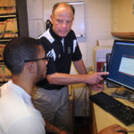 MINDUL APPROACH: Russell Fiore, standing, Brown University&rsquo;s head athletic trainer, conducts a test on a student athlete aimed at identifying cerebral concussions. / PBN PHOTO/FRANK MULLIN
