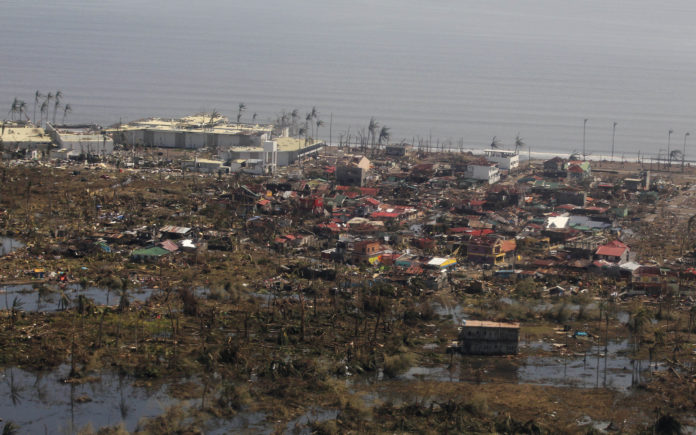 An aerial shot of the province of Leyte shows the extent of damage brought by Typhoon Haiyan in Leyte province, the Philippines, on Sunday, Nov. 10. On Tuesday, CVS Caremark announced a $50,000 donation to the American Red Cross, one of the multinational organizations accepting donations for disaster relief. / BLOOMBERG FILE PHOTO/RYAN LIM