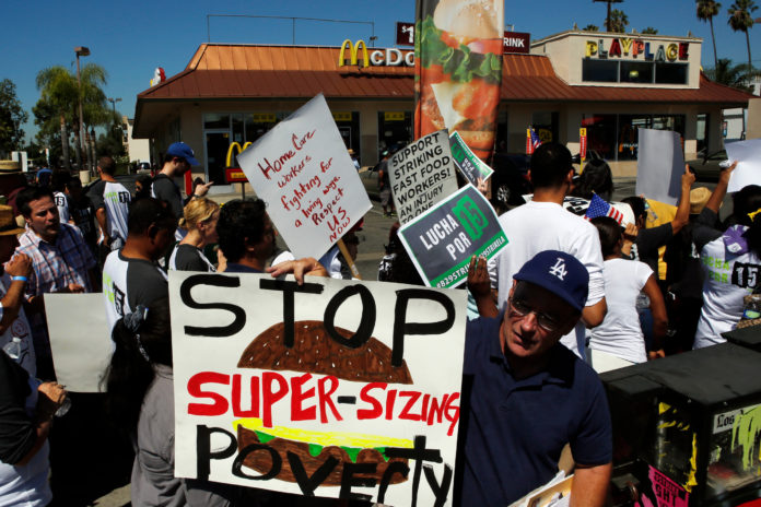 Fast-food workers and supporters organized by the Service Employees International Union protest outside of a McDonald's Corp. restaurant in Los Angeles, Calif., on Thursday, Aug. 29, ratcheting up pressure on the industry to raise wages. Rhode Island fast-food workers have planned a similar rally Thursday outside the Wendy's restaurant at 771 Warwick Ave. to demand their wages be raised to $15 per hour, drawing inspiration from the national campaign that led to strikes in Los Angeles and elsewhere. / BLOOMBERG FILE PHOTO/PATRICK T. FALLON