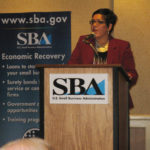 AT THE OPENING SESSION of the 2013 Rhode Island Economic Summit, Adriana Dawson, director of the R.I. Small Business Development Center, welcomes 190 business leaders and 30 members of the R.I. General Assembly. / PBN PHOTO/RHONDA MILLER