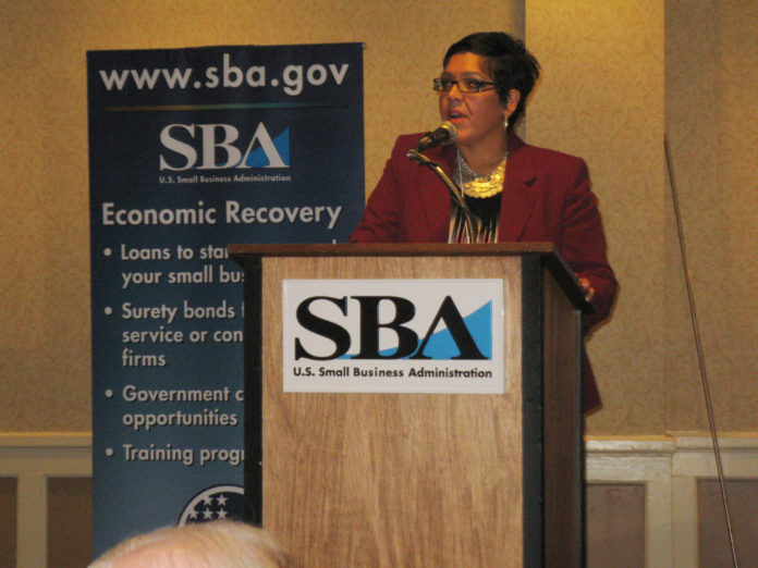AT THE OPENING SESSION of the 2013 Rhode Island Economic Summit, Adriana Dawson, director of the R.I. Small Business Development Center, welcomes 190 business leaders and 30 members of the R.I. General Assembly. / PBN PHOTO/RHONDA MILLER