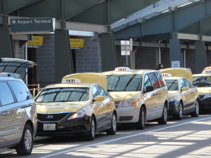 MAKING CONNECTIONS:  Taxis line up at T.F. Green Airport waiting for disembarking passengers, a consistent stream of business. / PBN PHOTO/MARK S. MURPHY