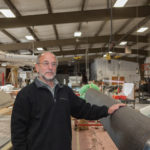 COMPOSITE SKETCH: David Schwartz, president of GMT Composites Inc., shows off one of his company&rsquo;s sailboat booms. GMT was founded in 1984 by a group of fiberglass and composites experts. / PBN FILE PHOTO/TRACY JENKINS