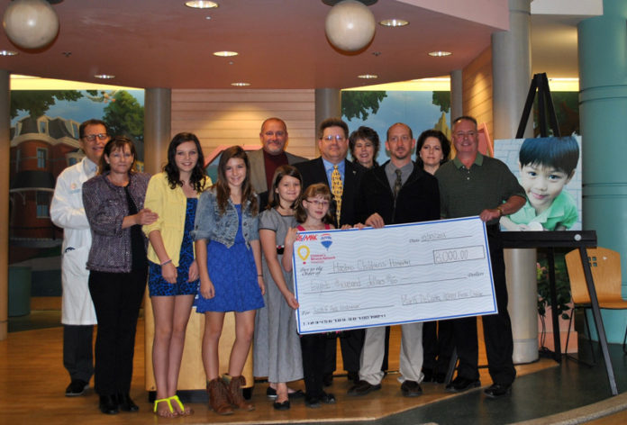 BLOCK PARTY event organizers present a check to the staff at Hasbro Children’s Hospital. From left: Dr. Robert B. Klein, pediatrician-in-chief, Hasbro Children’s Hospital; Carleen Villari; Liara Villari; Rachel Adams; Mark DeCosta, event organizer and agent at RE/MAX 1st Choice; Rachel DeCosta, event organizer, Mark DeCosta’s daughter; Manny Souza, RE/MAX 1st Choice; Lisa DeCosta; Kianna Hodde; Roger Hodde; Dan McCuster, RE/MAX 1st Choice; and Dianna Cordova.