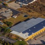 THE NEWLY EXTENDED Gannon & Scott manufacturing facility at 45 Sharp Dr. in Cranston doubles the facility's processing capacity and features a rooftop solar-panel array. At top left, Gannon & Scott's existing corporate headquarters and manufacturing facility. / COURTESY GANNON & SCOTT
