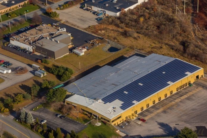 THE NEWLY EXTENDED Gannon & Scott manufacturing facility at 45 Sharp Dr. in Cranston doubles the facility's processing capacity and features a rooftop solar-panel array. At top left, Gannon & Scott's existing corporate headquarters and manufacturing facility. / COURTESY GANNON & SCOTT