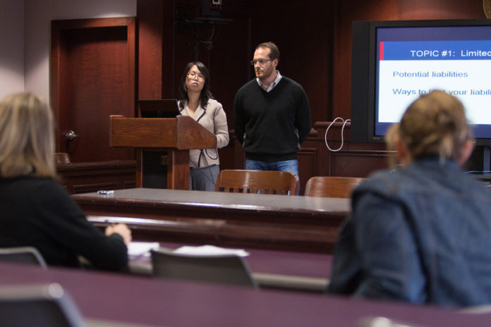 LETTER OF THE LAW: Roger Williams University law students Zoe Zhang and  Steve Sokolov present a run-through of issues for small businesses in front of other students and professor Gowri J. Krishna. / PBN PHOTO/RUPERT WHITELEY