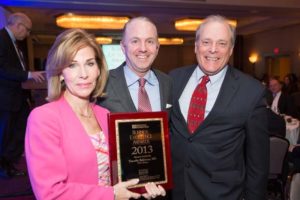Business Leadership Award Winner Dr. Timothy Babineau accepts his award from PBN's Nancy Adeszko and Mark Murphy / Rupert Whiteley