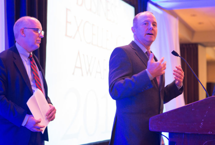 DR. TIMOTHY J. BABINEAU, right, president and CEO of Lifespan, accepts the award for Business Leadership from Providence Business News Publisher Roger C. Bergenheim at last week's BEA dinner, held at the Providence Marriott. / PBN PHOTO/RUPERT WHITELEY