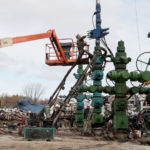 A WORKER CLEANS and lubricates the head of the machine, after the stimulation hydraulic fracturing or "fracking" of the well at Southwestern Energy Co.'s natural gas production site in Camptown, Penn. Methane leaked at fracking well sites can negate the environmental benefits of burning natural gas instead of coal, according to the U.S. Environmental Protection Agency. / BLOOMBERG FILE PHOTO/JULIA SCHMALZ