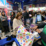 A CUSTOMER PERCHASES merchandise at a checkout counter at a Toys R Us Inc. store ahead of Black Friday in New York. U.S. retailers will kick off holiday shopping earlier than ever this year as stores prepare to sell some discounted items at a loss in a battle for consumers. / BLOOMBERG FILE PHOTO/PETER FOLEY