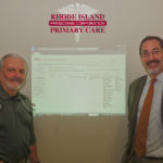 KEEPING TABS: Dr. Albert Puerini, left, CEO and president, Rhode Island Primary Care Physician Corp., and Noah Benedict, chief operating officer at the corporation, with the database. / COURTESY RHODE ISLAND  PRIMARY CARE PHYSICIAN CORP.