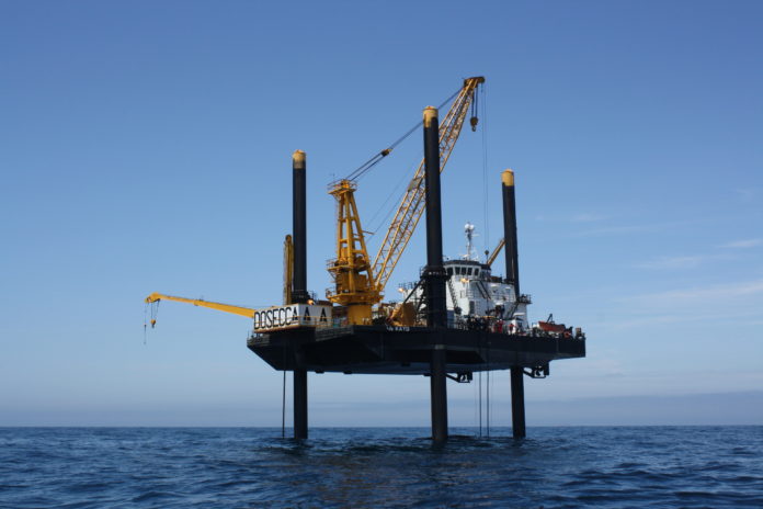A LIFT BOAT OFF BLOCK ISLAND does geological sampling for Deepwater Wind's Block Island Wind Farm in 2009 photo. Deepwater CEO Jeff Grybowski said Wednesday he expects the project to quality for a federal renewable-energy tax credit. / COURTESY DEEPWATER WIND