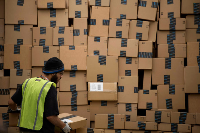 AN EMPLOYEE LOADS a truck at the Amazon.com Inc. fulfillment center in Phoenix, Ariz., on Monday, Dec. 2. Online sales on Cyber Monday surged 19 percent over last year, according to International Business Machines Corp. / BLOOMBERG FILE PHOTO/DAVID PAUL MORRIS