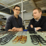Long view on hand-crafted frames SEEING CLEAR: Lee Allen Eyewear co-owners Lee Kuczewski, left, and Declan Haplin pose with some of their eyeglass frames. In addition to made-to-order, custom frames, Lee Allen also makes limited-edition designs sold at high-end shops. / PBN PHOTO/MARTIN GAVIN