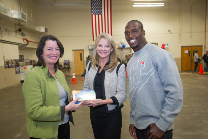 AT&T LENDS its support to troops serving abroad during a recent event in Warwick. From left: Rhode Island Lt. Gov. Elizabeth H. Roberts, left, with New England Patriot Devin McCourty and Patricia Jacobs, president, AT&T New England.
