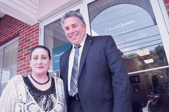 A FLEXIBLE SUPPORT SYSTEM: Edward Jones helps its financial advisers and branch administrators maintain a work-life balance while creating financial incentives for success. Pictured are Deborah Case, senior branch administrator, and Steven Grasso, financial adviser, in the Edward Jones office in Cranston. / PBN PHOTO/FRANK MULLIN