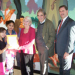 Grants spark creativity in R.I. classrooms FROM LEFT: Providence third-graders Natalia Bianchi and Keila Quinones hand thank-you cards to Letitia and John Carter and Rhode Island Foundation CEO Neil Steinberg after a press conference announcing the inaugural round of Spark Grants on Dec. 19. / COURTESY R.I. FOUNDATION