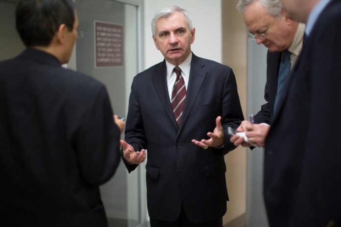 R.I. SEN. JACK REED, center, speaks to reporters after voting on the nomination of Janet Yellen as chairman of the U.S. Federal Reserve in Washington, D.C., U.S., on Monday. Yellen, currently Fed vice chairman, won U.S. Senate confirmation to become the 15th chairman of the Federal Reserve and the first woman to head the central bank in its 100-year history. / BLOOMBERG NEWS PHOTO/ANDREW HARRER