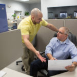 Moving from a statistic to gainful employment DEMANDING RESULTS: PC Troubleshooters remote support specialist Ty Holden left, speaks with IT On Demand graduate Ben Lyons. / PBN PHOTO/RUPERT WHITELEY