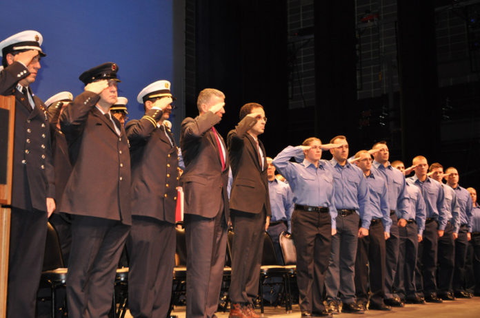 Following a 22-week training program, 54 men and women graduate on Jan. 3 from the 50th Providence Fire Department Training Academy. Graduates were sworn in as members of the department during the ceremony, held at Rhode Island College. For the first time in the department’s history a female candidate, 28-year-old Alison Philbrick, ranked No. 1 in the class. Joining in the ceremony was Mayor Angel Taveras, fifth from the left. / COURTESY OFFICE OF MAYOR ANGEL TAVERAS