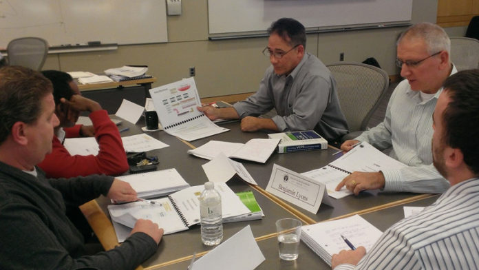 HARD AT WORK: Project management was part of the soft skills, or professional skills, training at Bryant University’s Executive Development Center. From top to right: Dan Chaput, Ben Lyons, Brendon Moore, Kevin Connelly and Michael Sillut. / COURTESY CHRIS SELWYN
