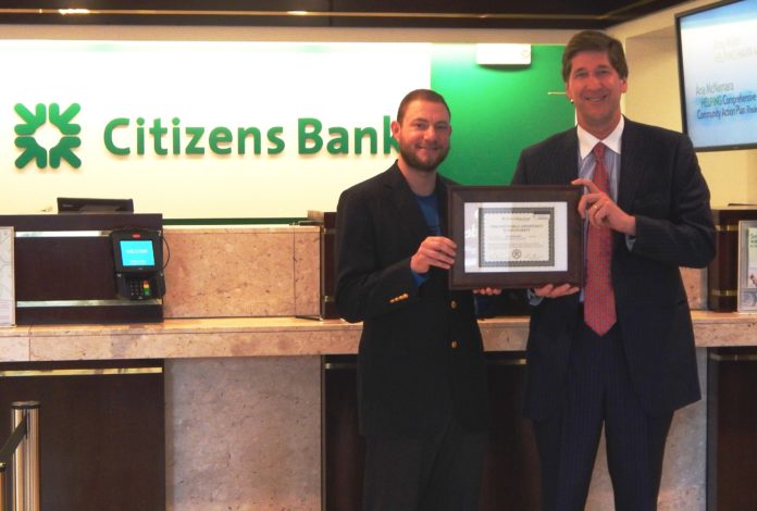 FOUNDER AND EXECUTIVE DIRECTOR of the Capital Good Fund Andy Posner, left, presents a stock certificate for  Social Innovation Shares to support the nonprofit IPO, in this case Immediate Public Opportunity,  to RBS Citizens Financial Group Chairman and CEO Bruce Van Saun.