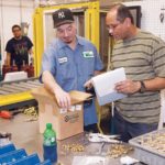 ON THE JOB: Johnny Bourdier, left, and Jean Sylva in the manufacturing production area at Taco Inc. / PBN PHOTO/TRACY JENKINS
