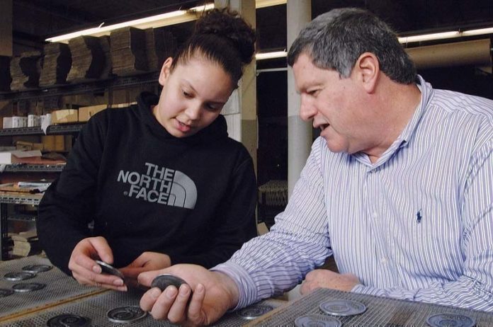 OPEN DIALOGUE: Peter Manickas, president of Metal Tile Technology, with employee Angalissa Reyes. Manickas sees value in sharing successes and failures with fellow businesses owners in the Entrepreneurial Exchange. / PBN FILE PHOTO/BRIAN MCDONALD
