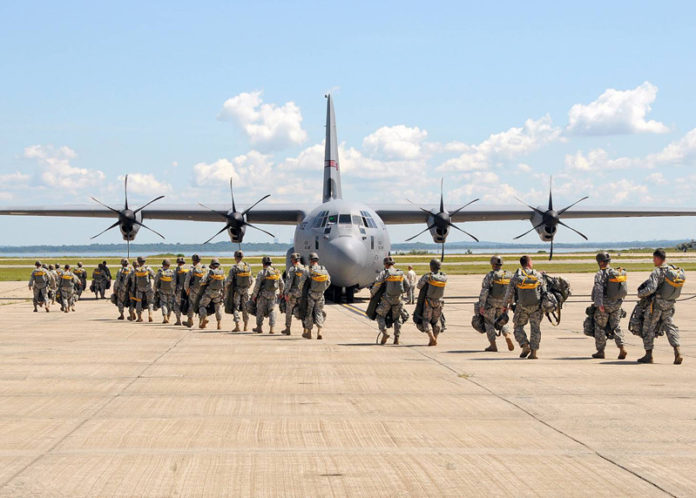 MISSION READY: Members of the 143rd Airborne Infantry Company and the 56th Troop Command, Rhode Island Army National Guard, prepare for a combat training jump out of a C-130J Super Hercules. / COURTESY MASTER SERGEANT JANEEN MILLER