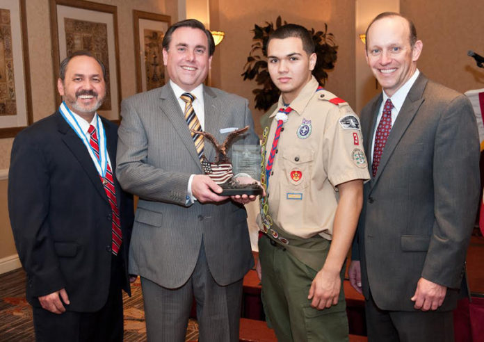 THE VALE LA PENA AWARD recognizes Dexter Credit Union for providing youth with the tools to help them reach their highest potential. From left: Tomas E. Ramirez, Stephen J. Angell, president and CEO, Dexter Credit Union, Sebastian Zuleta and John H. Mosby, Boy Scouts of America.