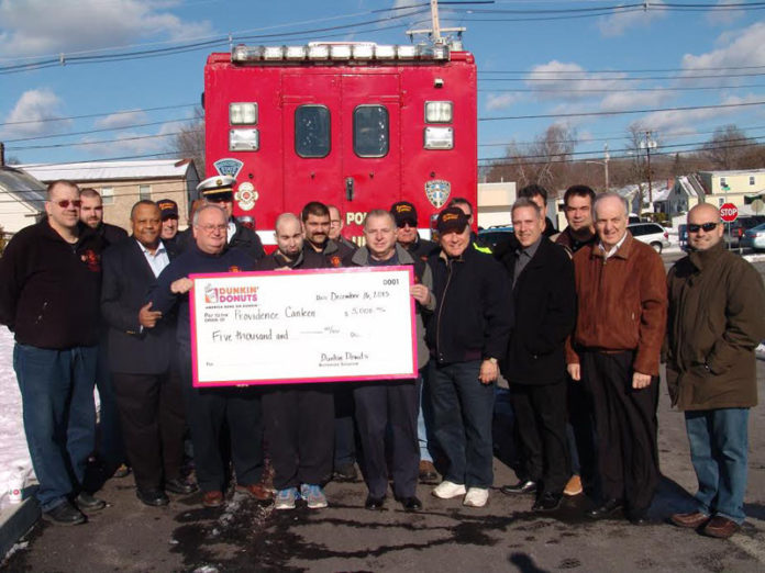 VOLUNTEERS WITH the Providence Canteen accept a $5,000 donation from Dunkin’ Donuts franchisees in Rhode Island and Bristol County, Mass.