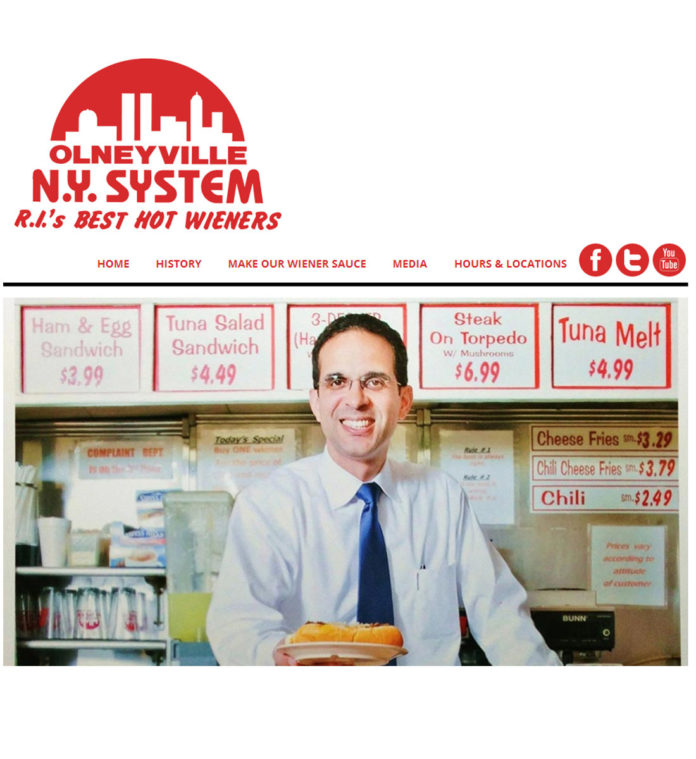 OLNEYVILLE NEW YORK System was one of five restaurants nationwide to receive a 2014 America's Classics Award from the James Beard Foundation. Above, Providence Mayor Angel Taveras poses with one of the diner's signature weiners in a photo featured on the restaurant's website. / COURTESY OLNEYVILLE NEW YORK SYSTEM
