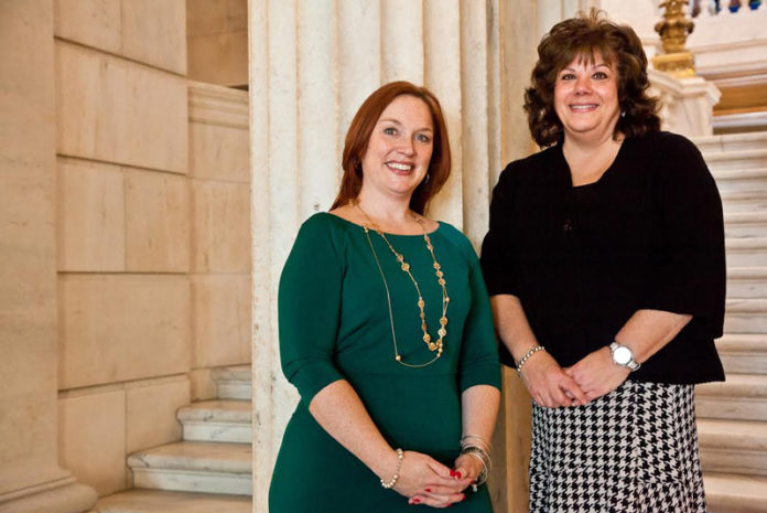 CAROLYN BELISLE, left, director of Community Relations for Blue Cross & Blue Shield of Rhode Island, and Joanne McGunagle, executive director of Comprehensive Community Action Program in Cranston, were honored by United Way of Rhode Island at the Statehouse on National 2-1-1 Day.