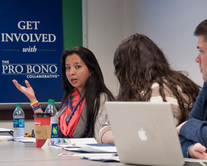 CROSSING BORDERS: Camila Bernal, left, an attorney from Columbia, speaks with 2013 RWU Law School graduates Angela Lawless and Dennis Costigan about representing undocumented children and about the Pro Bono Collaborative. / PBN PHOTO/MICHAEL SALERNO