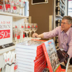 Anniversaries time to
celebrate, buff image TURNING A PAGE: Ken St. Martin, assistant director of Brown University Bookstore, prepares a display marking the school’s upcoming anniversary. / PBN PHOTO/TRACY JENKINS