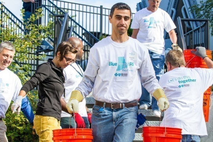 CONNECTING WITH COMMUNITY: Volunteers from Blue Cross & Blue Shield of Rhode Island help the Thundermist Health Center in West Warwick build a garden. / COURTESY DT PHOTOGRAPHY/BLUE CROSS & BLUE SHIELD OF RHODE ISLAND
