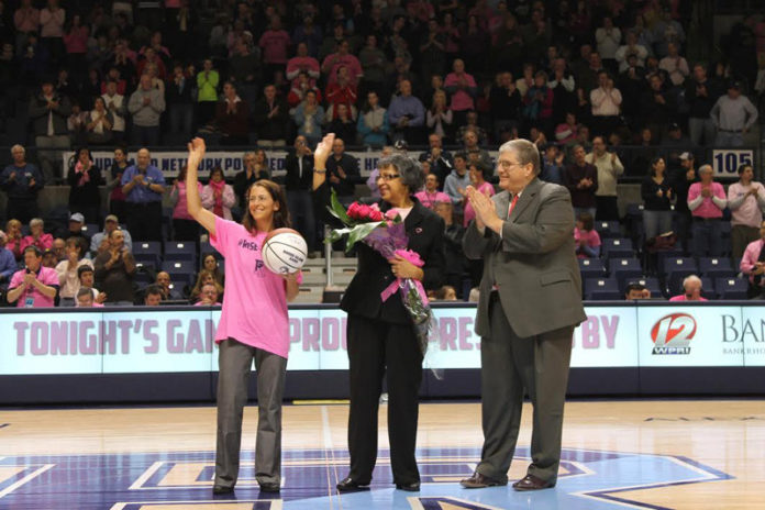 DURING AN EVENING made possible by sponsors Bank Rhode Island and South County Hospital, BankRI President and CEO Mark Meiklejohn, right, presented Trudy Rawles, center, with a bouquet of pink roses to honor her triumph over breast cancer. They are joined by Diane Paggioli, an oncologist with South County Hospital.