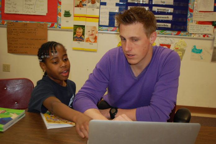 GO GETTER: Shandanea Hayden, a scholarship recipient from Warren, works with her second grade teacher, Mike Skazinski, at Barrington Christian Academy. / COURTESY ELSIE WRIGHT