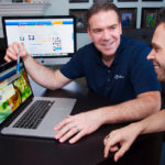 Hooking online job-search clients EASY TO SWALLOW: Gulpfish.com owner Ilya Reikhrud, left, reviews an employer’s profile with Greg Silva, the company’s editor, blogger and public relations manager. Goals for the company include building an online recruiting system for hard-to-fill positions that require specially qualified candidates, Reikhrud said. / PBN PHOTO/MICHAEL SALERNO