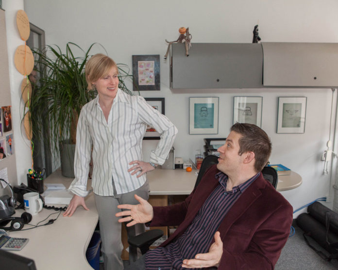 INDISPENSIBLY ACTIVE: Britte Jessen-Balint, controller of Envision Technology Advisors, talks with Jeremy Girard, directing of marketing. From starting as a receptionist at the company, Jessen-Balint has taken on a great variety of tasks to help the company continue to grow. / PBN PHOTO/TRACY JENKINS