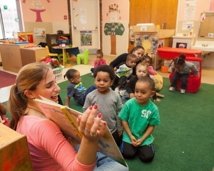SHINING BRIGHT: Debbie Durant, director of the Smith Hill Early Childhood Learning Center, works with children at the Providence nonprofit. She praises the BrightStars system for helping the center raise its rating. / PBN PHOTO/TRACY JENKINS