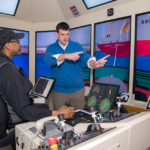 CONFIDENT APPROACH: J. Kent Dresser, right, president of Confident Captain/Ocean Pros, gives some tips to Calvin Rogers. Dresser makes the most of the quieter winter season by offering land-based training. / PBN PHOTO/MICHAEL SALERNO